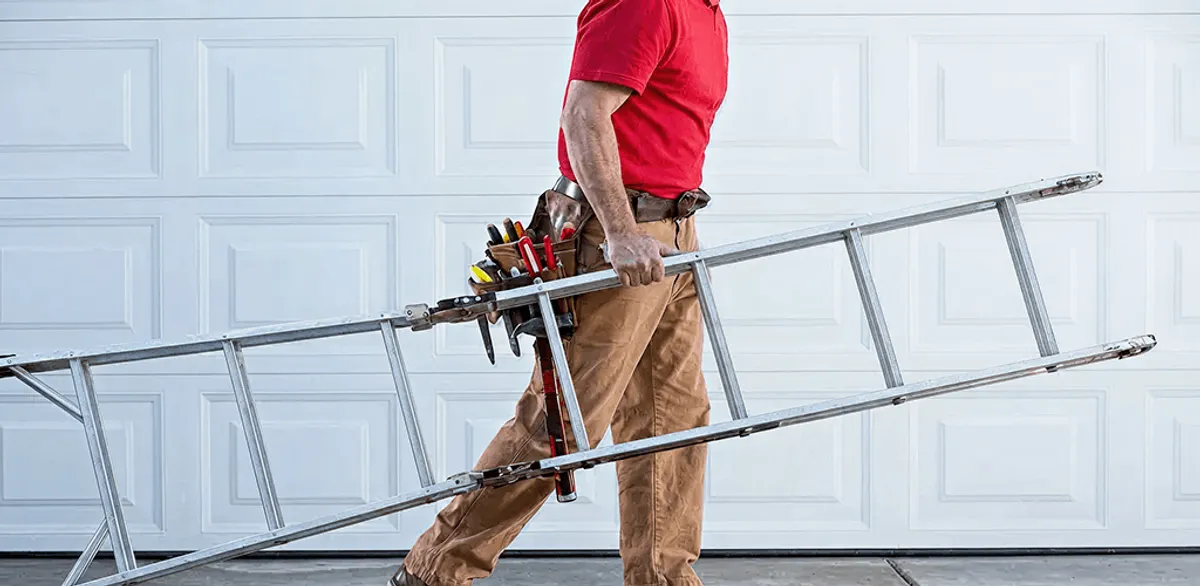 Garage door repair technician arriving with tools and ladder in Kansas City, MO