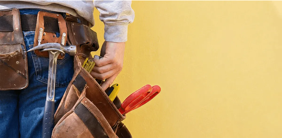 Handyman with tool belt ready for home repairs and maintenance in Kansas City, MO